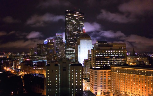 Image city buildings under dark cloudy sky during night time