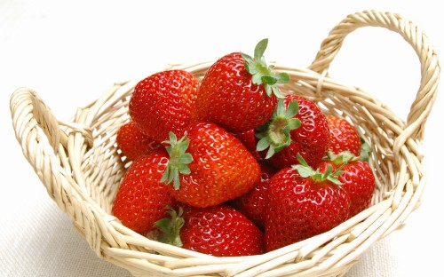 Image strawberries in brown woven basket