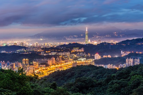 Image city skyline under blue sky during night time