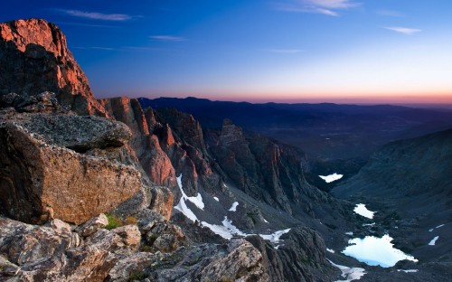 Image rocky mountain near body of water during daytime