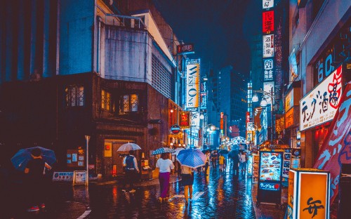 Image people walking on street during night time