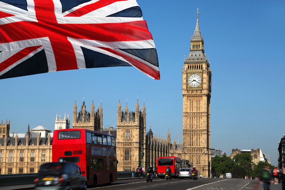 red double decker bus on road near big ben during daytime