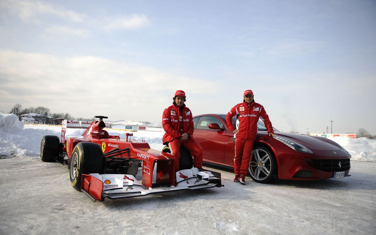 3 men in red car on snow covered ground during daytime