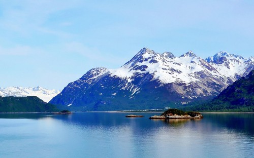 Image snow covered mountain near lake during daytime