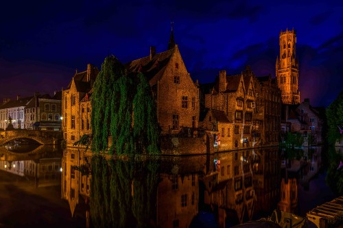 Image brown concrete building near body of water during night time