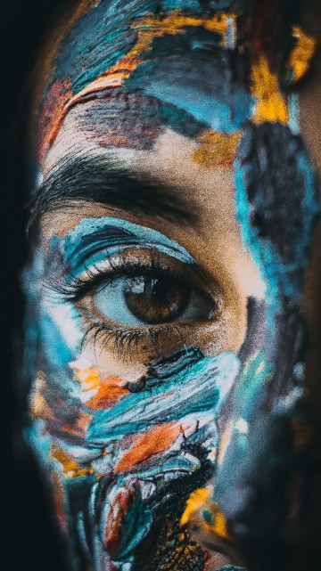 Image person with blue and yellow paint on face