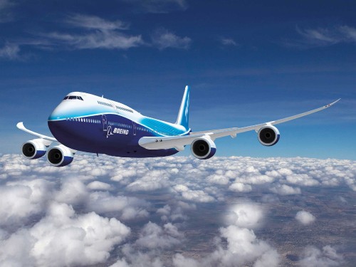 Image white and blue airplane flying under blue sky during daytime