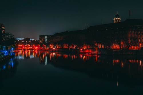 Image body of water near city buildings during night time