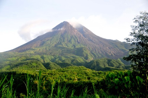 Image green and brown mountain under white clouds during daytime