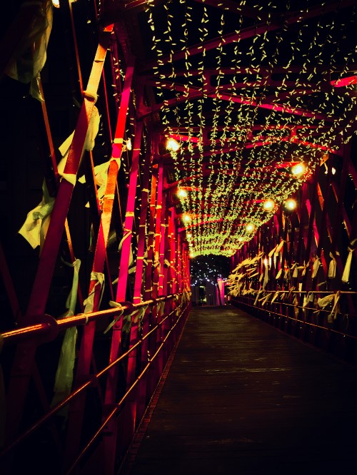 Image red string lights on brown wooden bridge