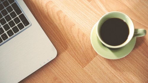 Image white ceramic mug on brown wooden table