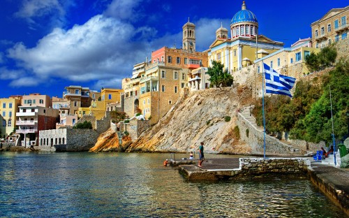 Image white and blue dome building on brown wooden dock during daytime