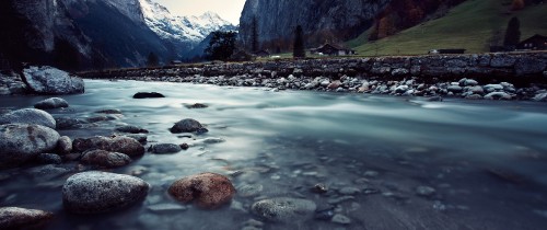 Image brown rock on river near mountain during daytime