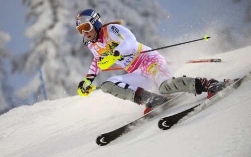 Image person in white and pink jacket and pants riding on white snow board during daytime