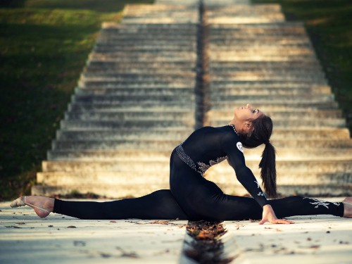 Image woman in black long sleeve dress lying on ground during daytime