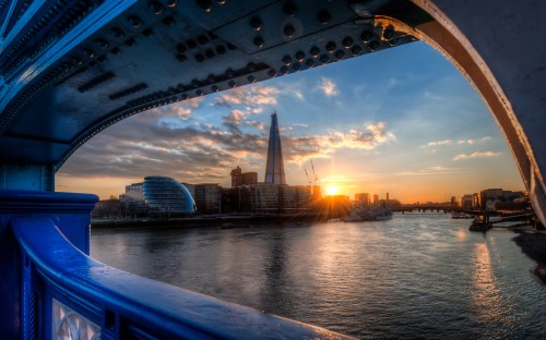 Image body of water near city buildings during sunset