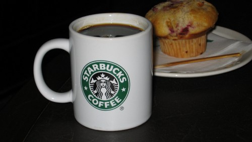 Image white and green ceramic mug with coffee