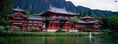 Image red and white temple near lake during daytime