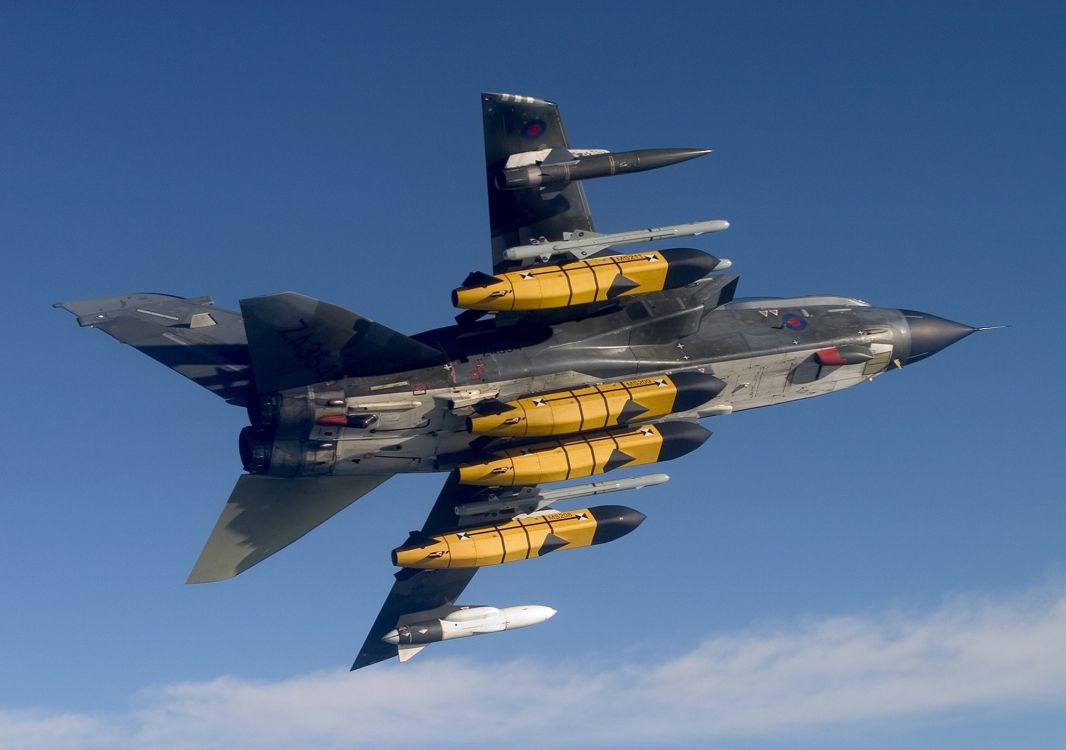 black and yellow fighter jet flying in the sky