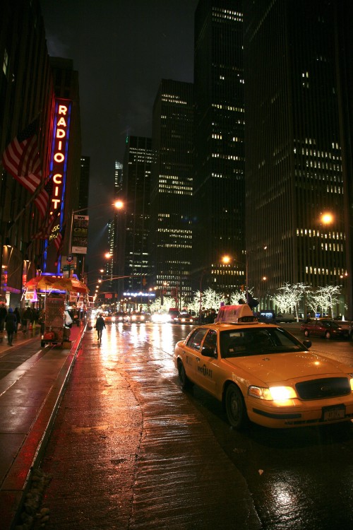 Image cars on road near high rise buildings during night time