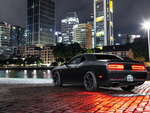 Image black coupe parked near body of water during daytime