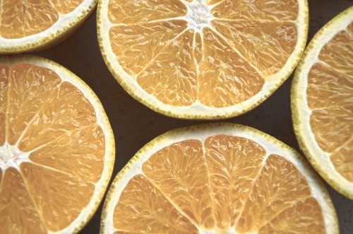 Image sliced orange fruit on black surface