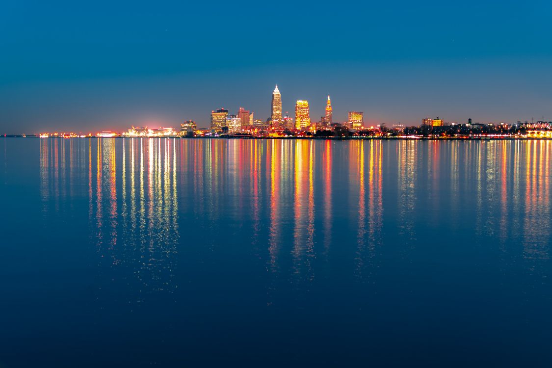 City Skyline Across Body of Water During Night Time. Wallpaper in 5568x3712 Resolution