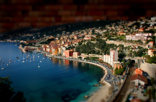 Image aerial view of city buildings near body of water during daytime