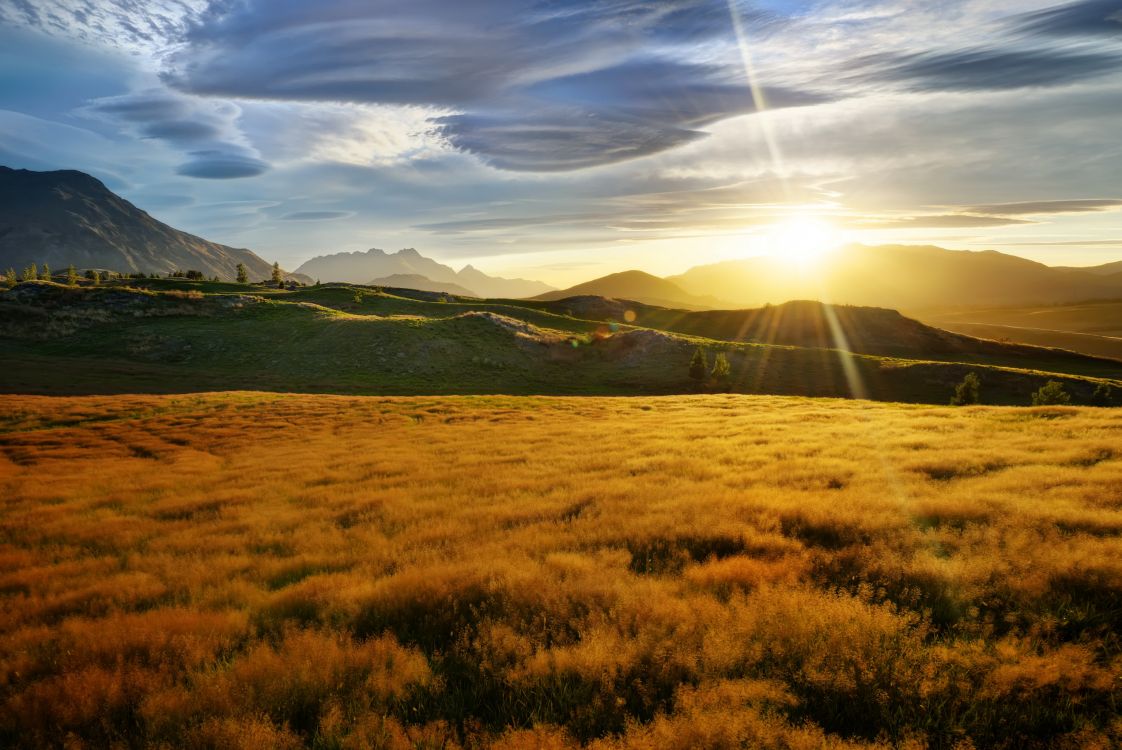 Green Grass Field Near Mountain Under Blue Sky During Daytime. Wallpaper in 3072x2052 Resolution