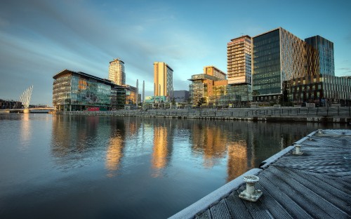 Image city skyline across body of water during daytime