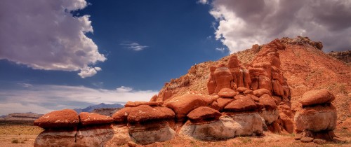 Image brown rocky mountain under blue sky and white clouds during daytime