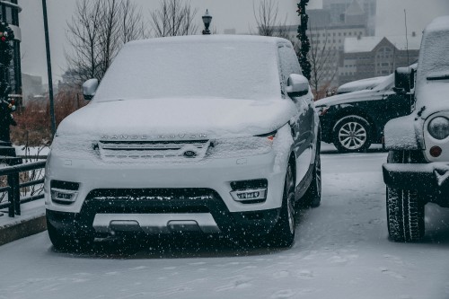 Image white chevrolet car covered with snow