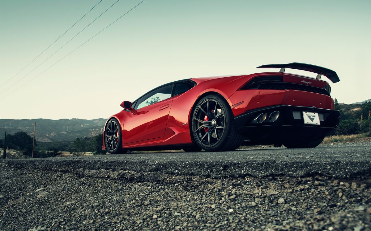 red ferrari 458 italia on gray concrete road