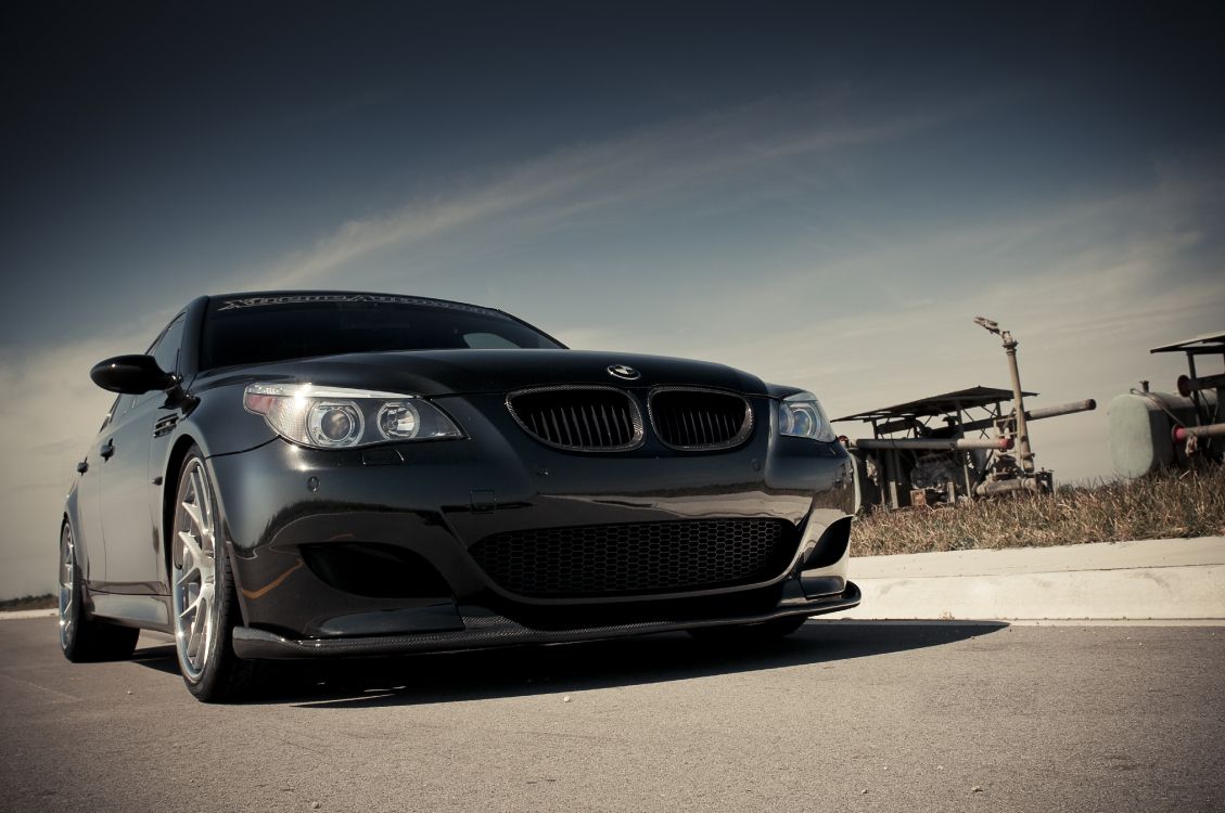 black bmw car on gray asphalt road during daytime