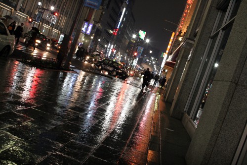 Image people walking on sidewalk during night time