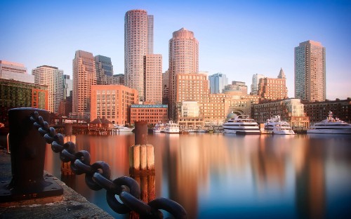 Image city skyline across body of water during daytime