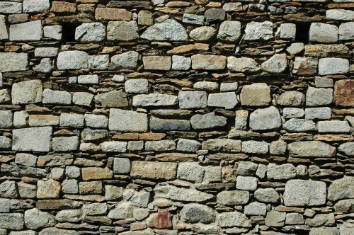 Image red fire extinguisher on brown brick wall