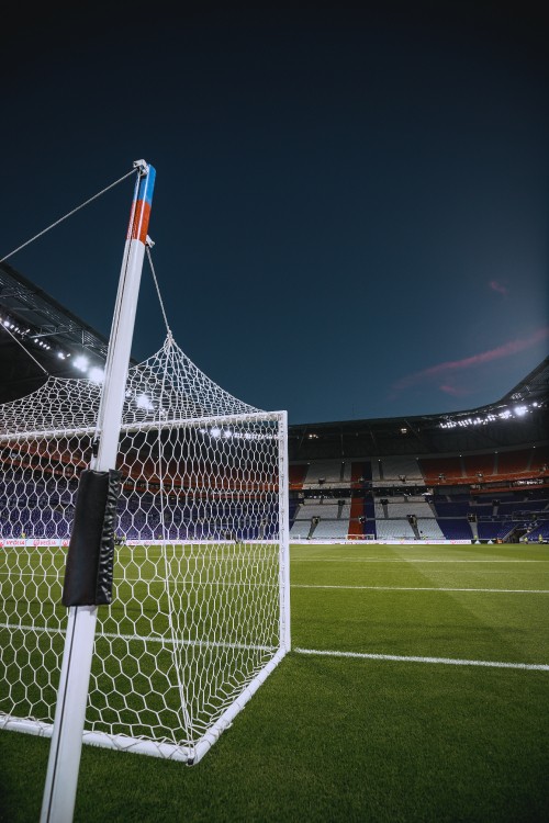 Image white and red flag on soccer field during night time