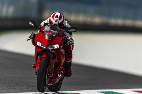 Image man in red and black motorcycle helmet riding on red sports bike