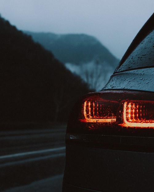 Image black car on road during night time