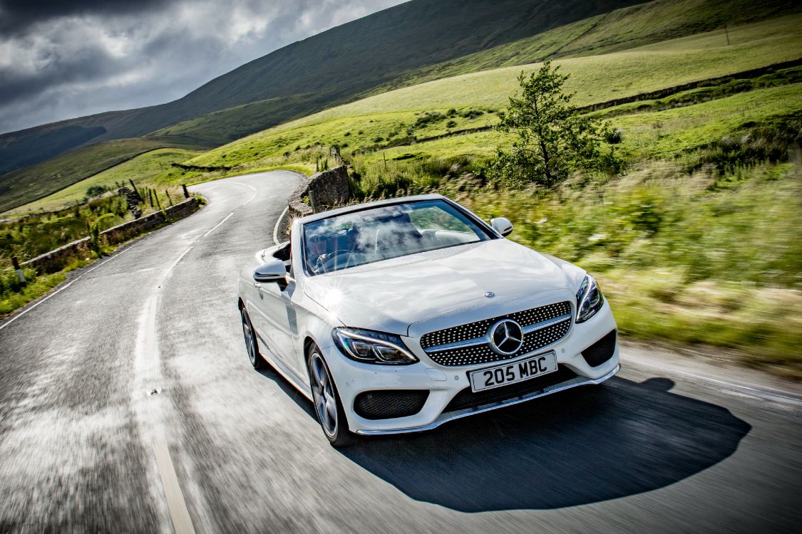 white mercedes benz coupe on road during daytime