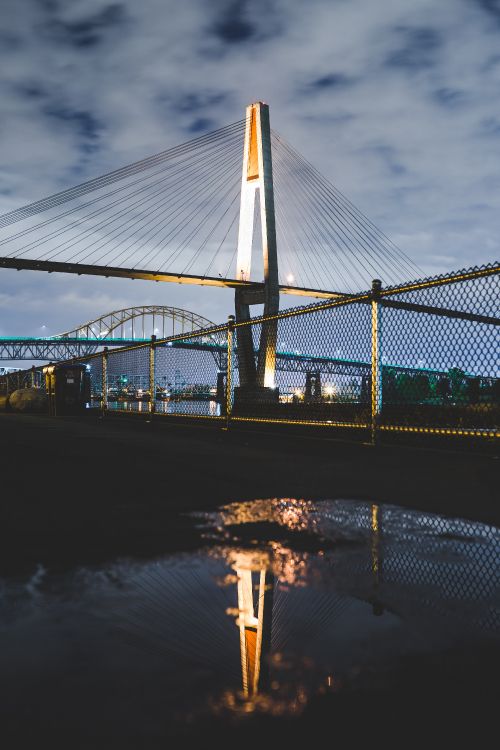 Bridge Over Water During Night Time. Wallpaper in 3697x5545 Resolution
