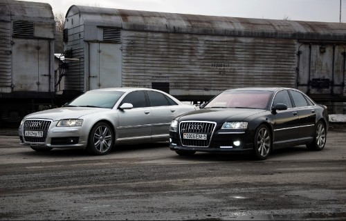 Image silver audi sedan parked beside brown brick building