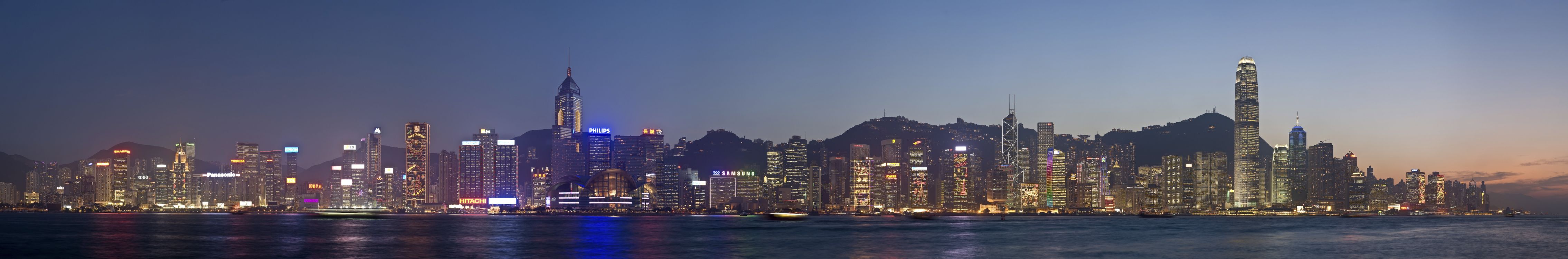 city skyline near body of water during night time