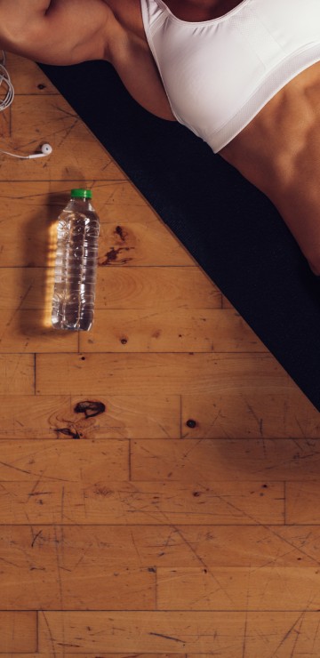 Image person in white tank top and black shorts