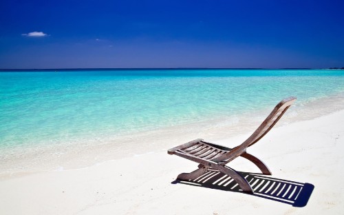 Image black wooden lounge chair on beach during daytime