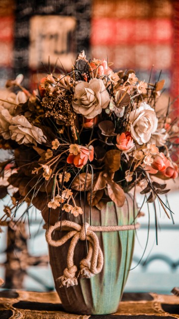 Image brown and white flowers in green ceramic vase
