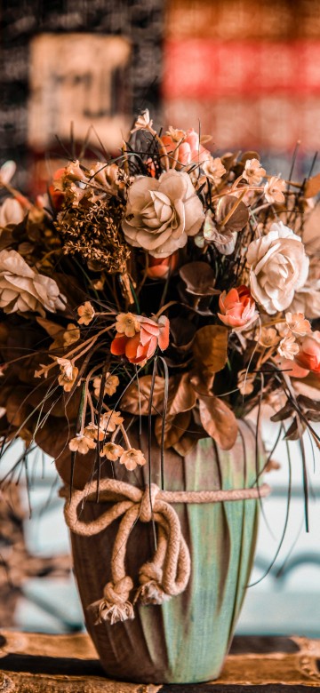 Image brown and white flowers in green ceramic vase