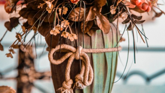 Image brown and white flowers in green ceramic vase