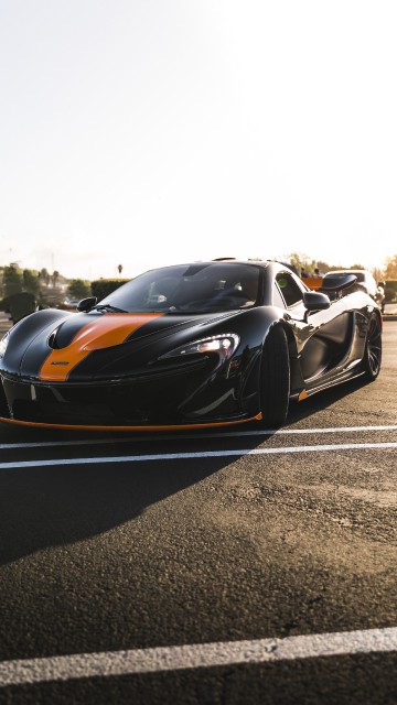 Image black and orange sports car on road during daytime